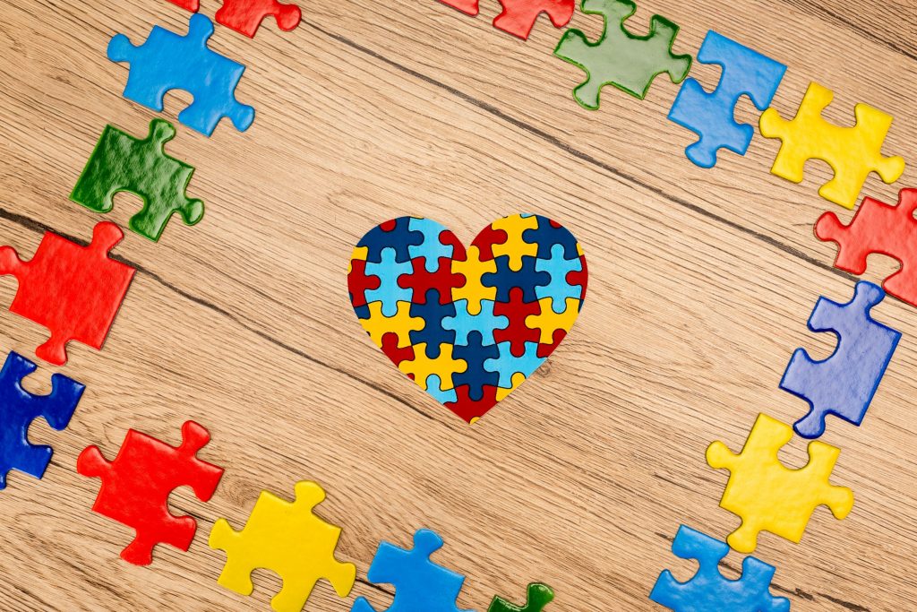 heart shaped jigsaw puzzle on a wood floor with puzzle border - NY Special Needs Planning